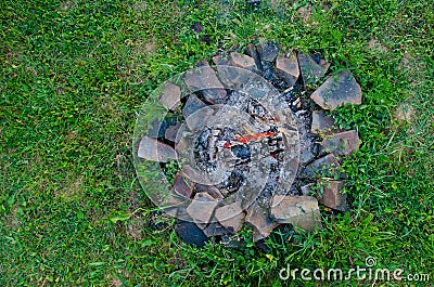 Outdoor stone fireplace in green grass. Stock Photo