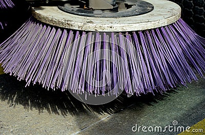 Outdoor sweeper. using round brushes with plastic purple brushes. Cleaning gravel and clutter in the city streets after constructi Stock Photo
