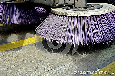 Outdoor sweeper. using round brushes with plastic purple brushes. Cleaning gravel and clutter in the city streets after constructi Stock Photo