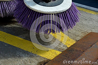 Outdoor sweeper. using round brushes with plastic purple brushes. Cleaning gravel and clutter in the city streets after constructi Stock Photo
