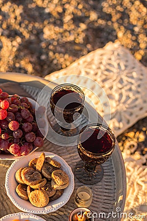 Outdoor table arrangement with glasses of wine, dried fruits and Stock Photo