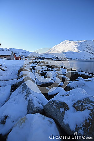 Outdoor view of snow laying over rocks near Ersfjordbotn Stock Photo