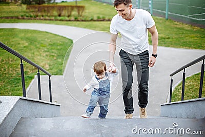 Outdoor walking father and daughter. Child and dad walk in the summer Stock Photo