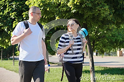 Outdoor walking man and woman, talking people middle-aged couple Stock Photo