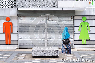 Outdoor wall with signs of men and women separated by a door. Icon wc. Stock Photo