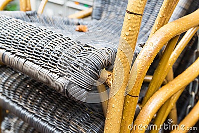 Outdoor wicker chairs after rain with raindrops Stock Photo