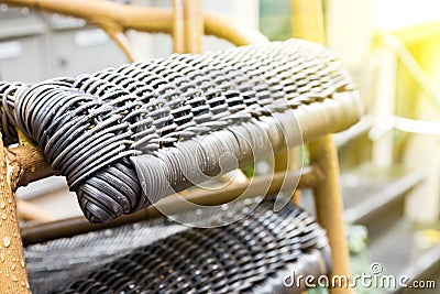 Outdoor wicker chairs after rain with raindrops. The sun shines after the rain Stock Photo