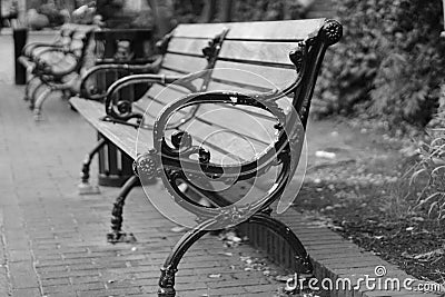 Outdoor wooden slat bench on a stone street floor Stock Photo