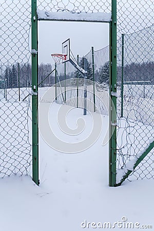 Outdoors basketball court covered with snow in winter Stock Photo
