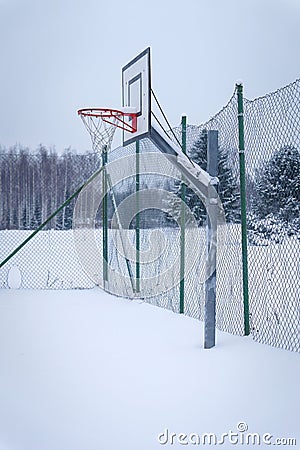 Outdoors basketball court covered with snow in winter Stock Photo