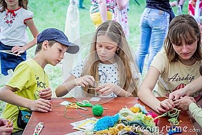 Outdoors children activity - knitting workshop Editorial Stock Photo