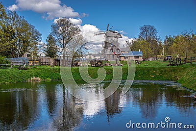 Old windmill and lake Stock Photo