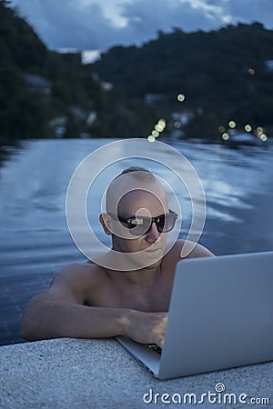Outdoors portrait of handsome young man with laptop computer Stock Photo