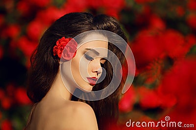 Outdoors portrait of Natural Beauty woman in red roses. Sensual Stock Photo