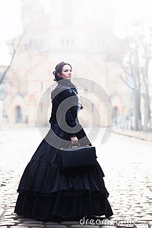 Outdoors portrait of a victorian lady in black Stock Photo