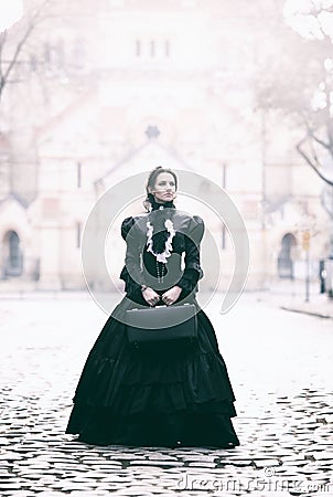 Outdoors portrait of a victorian lady in black Stock Photo