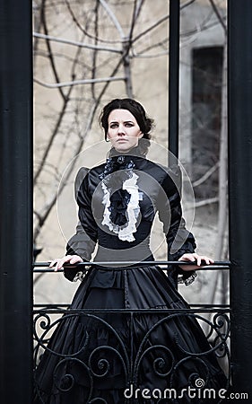 Outdoors portrait of a victorian lady in black Stock Photo