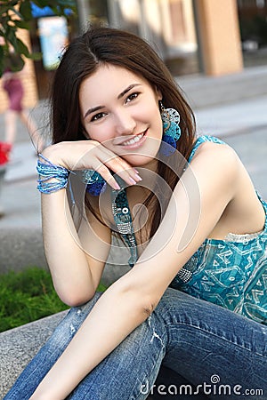 Outdoors street portrait of beautiful young brunette girl Stock Photo