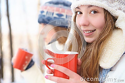 Outdoors on a winter day. Girls drink tea. Stock Photo