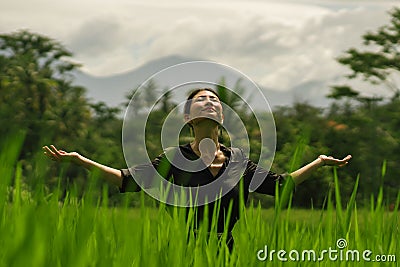 Outdoors yoga and meditation at rice field - attractive and happy middle aged Asian Japanese woman enjoying yoga and relaxation in Stock Photo