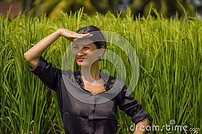 Outdoors yoga and meditation at rice field - attractive and happy middle aged Asian Japanese woman enjoying yoga and relaxation in Stock Photo