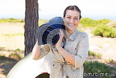 Outdoorsy woman smiling at camera outside her tent Stock Photo