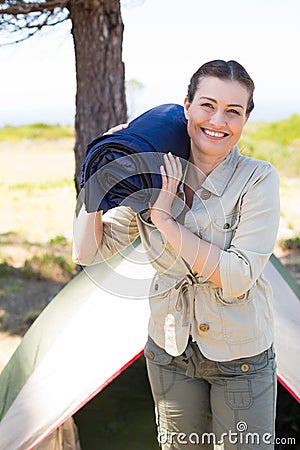 Outdoorsy woman smiling at camera outside her tent Stock Photo