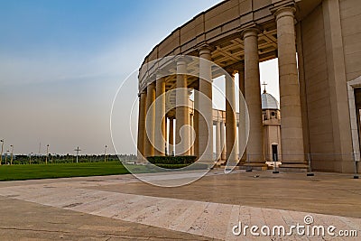 Outer view of one of the colonnades of the Basilica of Our Lady of Peace with the setting sun to the west Stock Photo