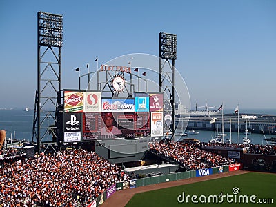 Outfield, packed bleachers, Scoreboard featuring line-up and Shane Victorino, and boats in McCovey Cove Editorial Stock Photo