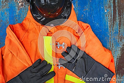 Outfit of Firefighter placed on old table background. Stock Photo