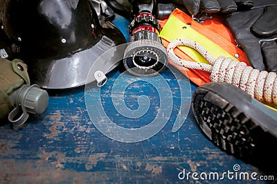 Outfit of Firefighter placed on old table background. Stock Photo