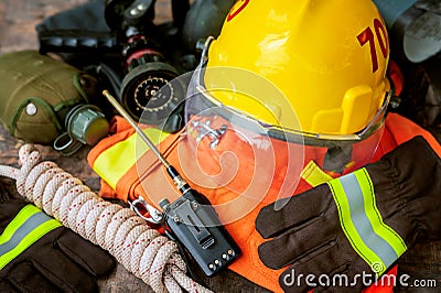 Outfit of Firefighter placed on wooden table background. Stock Photo