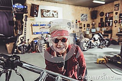 Outgoing female retiree locating on bike Stock Photo