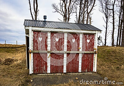 Outhouse toilet with four closed and locked doors Stock Photo