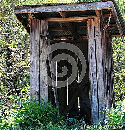 Outhouse in the woods Stock Photo