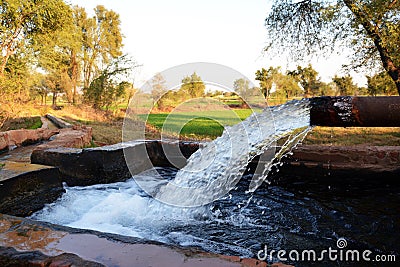 Outlet of a tube well to a temporary reservoir in a small village of Pakistan Stock Photo