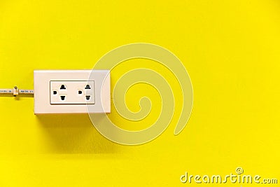 The outlet on yellow wall Stock Photo