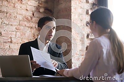 Outrage boss talking to employee, pointing to error in document Stock Photo