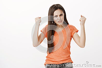 Outraged woman wants to punch offender in face. Portrait of angry displeased attractive female student, frowning Stock Photo