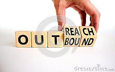 Outreach or outbound symbol. Businessman turns wooden cubes and changes the word `outbound` to `outreach`. Beautiful white tab Stock Photo