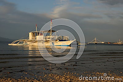 Outrigger boats at sunset Stock Photo