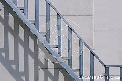 Outside steel baluster with staircase structure on gray smartboard wall background in house construction site Stock Photo