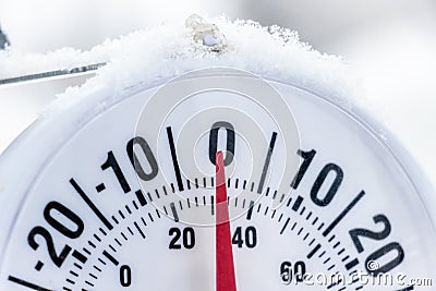Outside thermometer showing lightly under frozen temperature, zero Celcius degrees or minus 32 Farhenheit Stock Photo