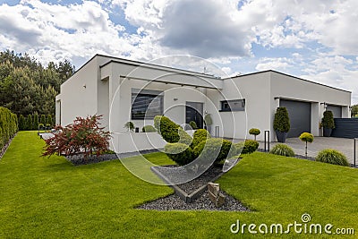 Elegant suburban house with big window green lawn Stock Photo