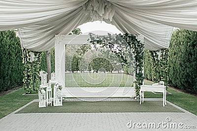 outside wedding white wall. green garden decor with drapings Stock Photo
