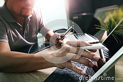 Outsource Developer working on marble Desk Working Laptop Computer Mobile Application Software and digital tablet dock smart Stock Photo