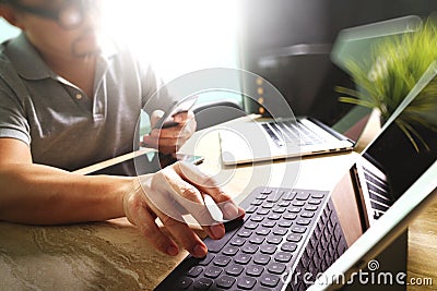 Outsource Developer working on marble Desk Working Laptop Computer Mobile Application Software and digital tablet dock smart Stock Photo