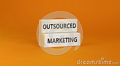 Outsourced marketing symbol. Concept words Outsourced marketing on beautiful wooden blocks. Beautiful orange table orange Stock Photo