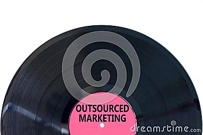 Outsourced marketing symbol. Concept words Outsourced marketing on beautiful black vinyl disk. Beautiful white table white Stock Photo