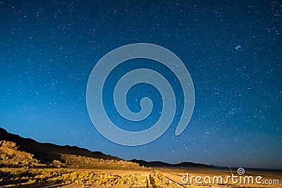 Outstanding starry sky at high altitude on the barren highlands of the Andes in Bolivia. Football ground soccer field in the mid Stock Photo